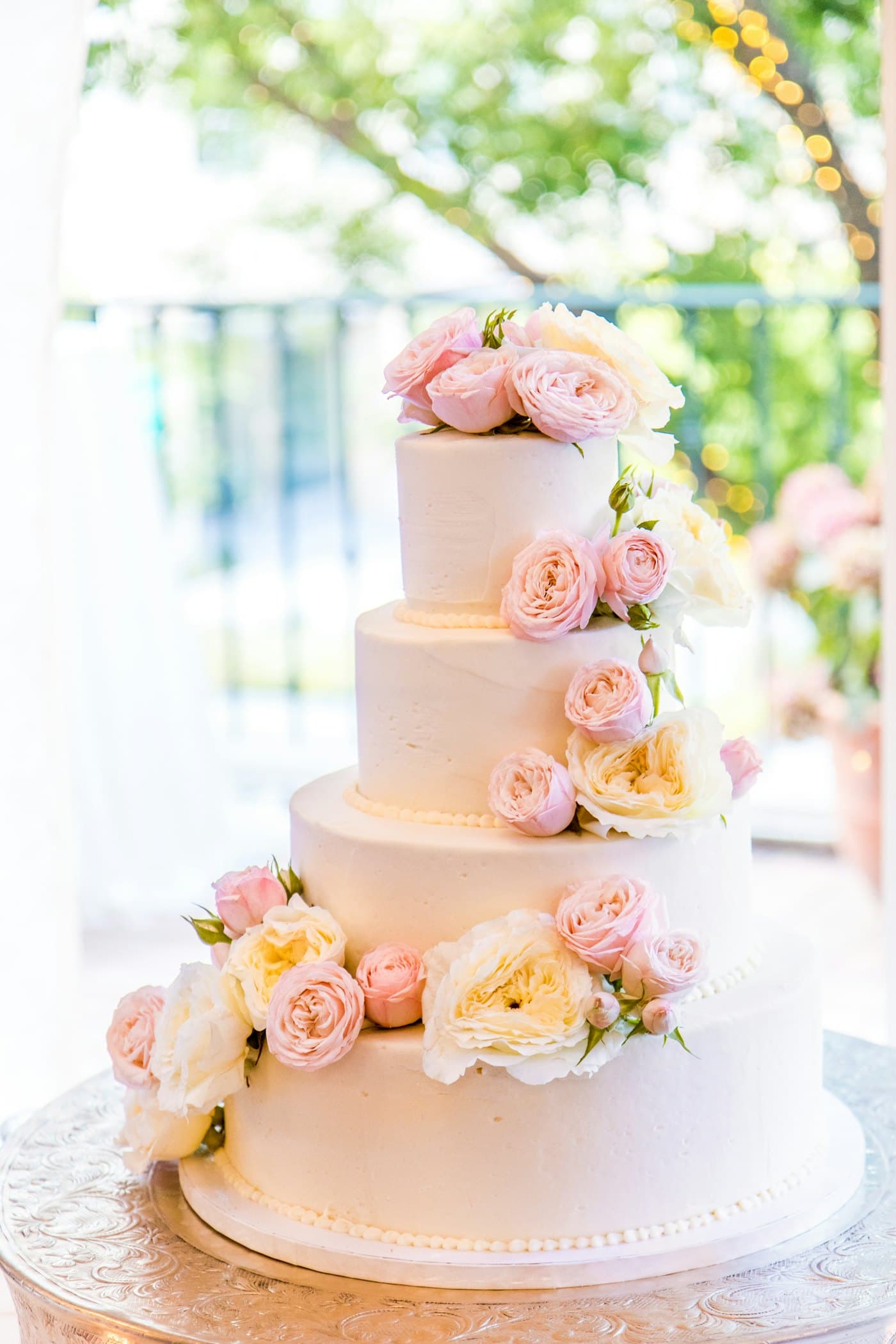 A three-tier wedding cake with flowers