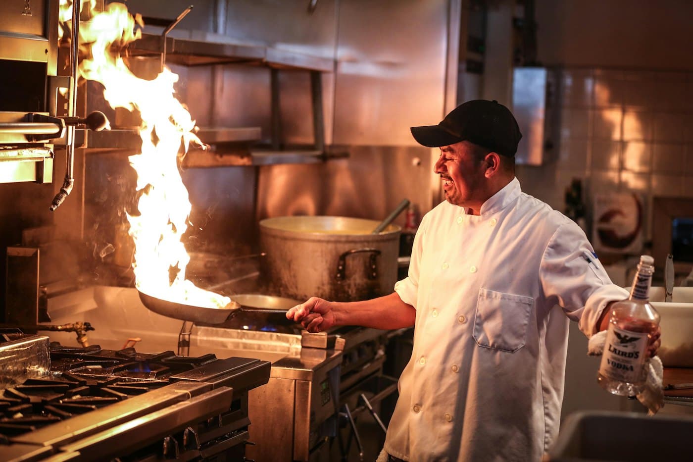 A chef cooking over flames