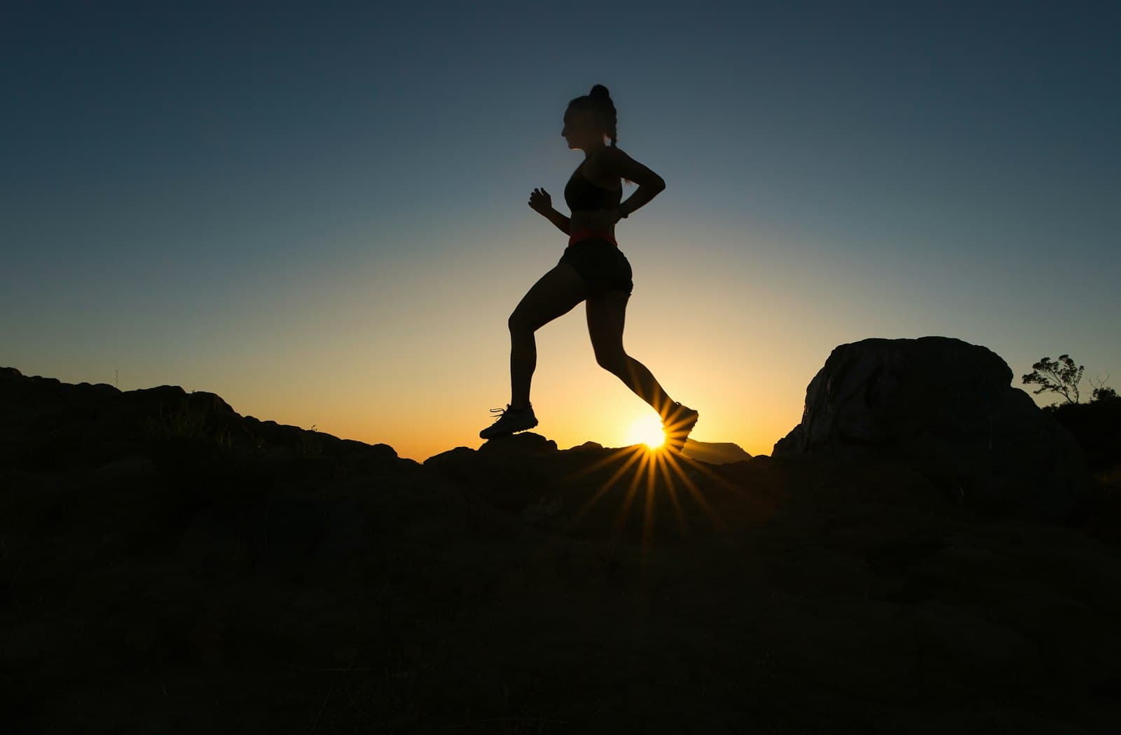 A runner in silhouette at sunset