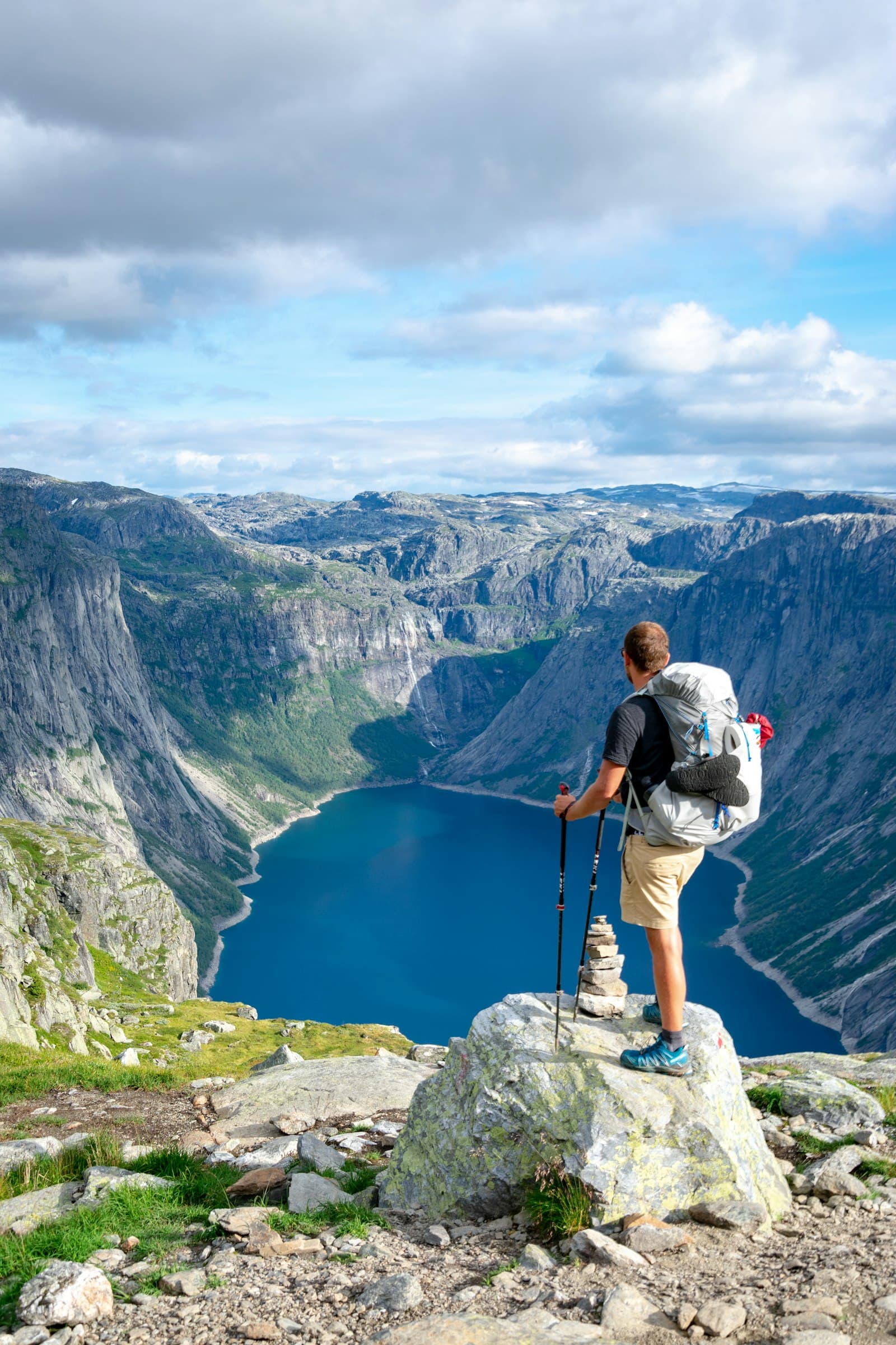 A hiker above a mountain lake